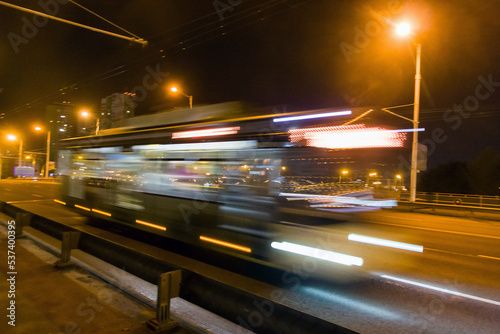 A blurred bus moves along the overpass in the evening. © leon134865