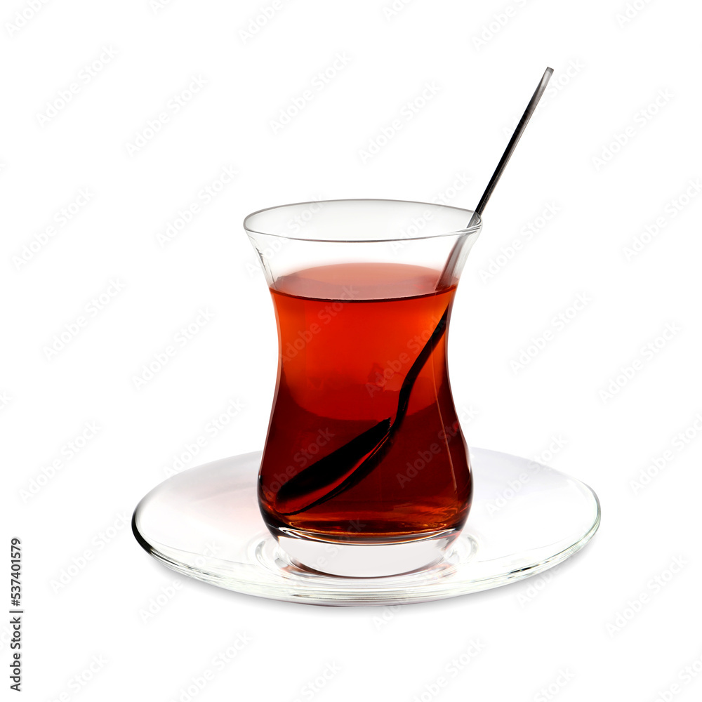 Glass of traditional Turkish tea with spoon isolated on white Glass of traditional Turkish tea with spoon isolated on white
