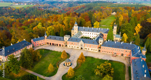 Scenic autumn landscape with large Castle complex near village of Sychrov with romantic neogothic building and English style park, Czech Republic.. photo