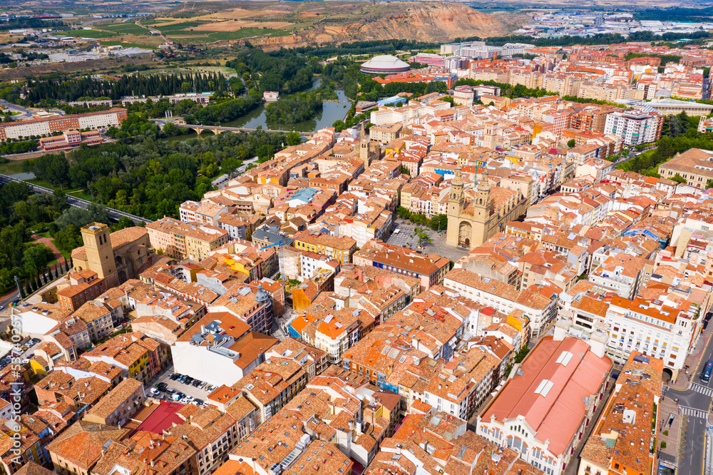 Aerial view of Logrono cityscape on banks of Ebro river overlooking spires of Co-cathedral of Santa Maria in summer day, Spain..