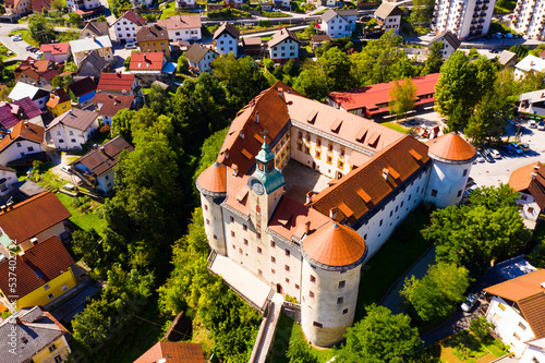 Aerial view of impressive medieval Gewerkenegg Castle in small Slovenian township of Idrija on sunny autumn day