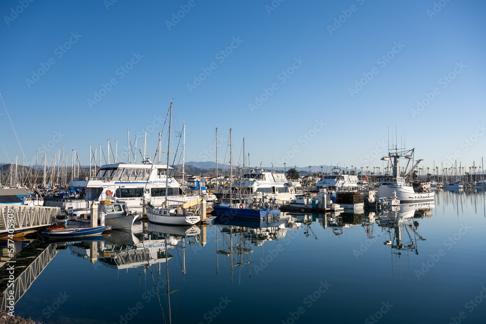 Boats Reflect in Calm Harbor Water