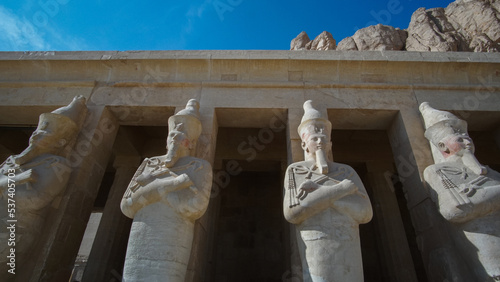 Mortuary temple of hatshepsut at Valley pf the kings detail row of Osiride statues wearing white crown sculpture photo