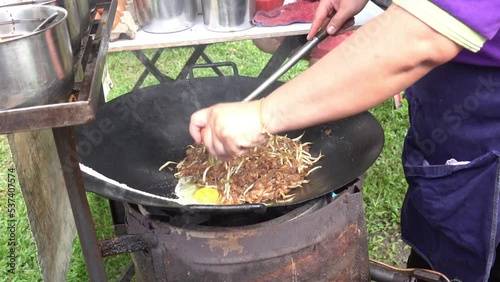 Penang, Malaysia 07172020- Farlim night market Char Kuey Teow adding eggs. photo