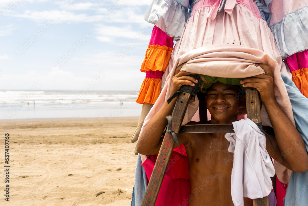 Nicaraguan young man carrying a gigantona on the beach of Masachapa, Nicaraguan tradition