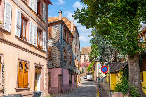 Fototapeta Naklejka Na Ścianę i Meble -  One of the many picturesque and colorful streets and alleys of half-timbered buildings in the medieval village of Ribeauville, France, in the Alsace wine region of Northeast France.
