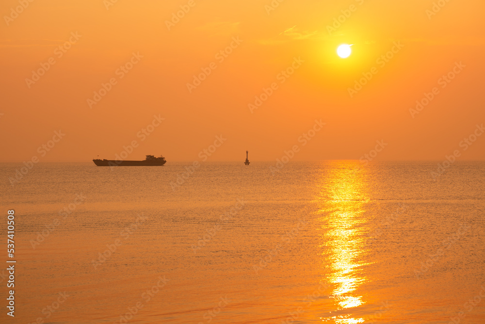 ship on the horizon at sunset