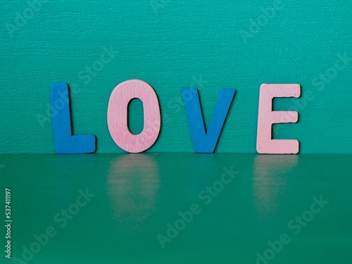 The word love written with letter wooden ,Green background,Valentines Day