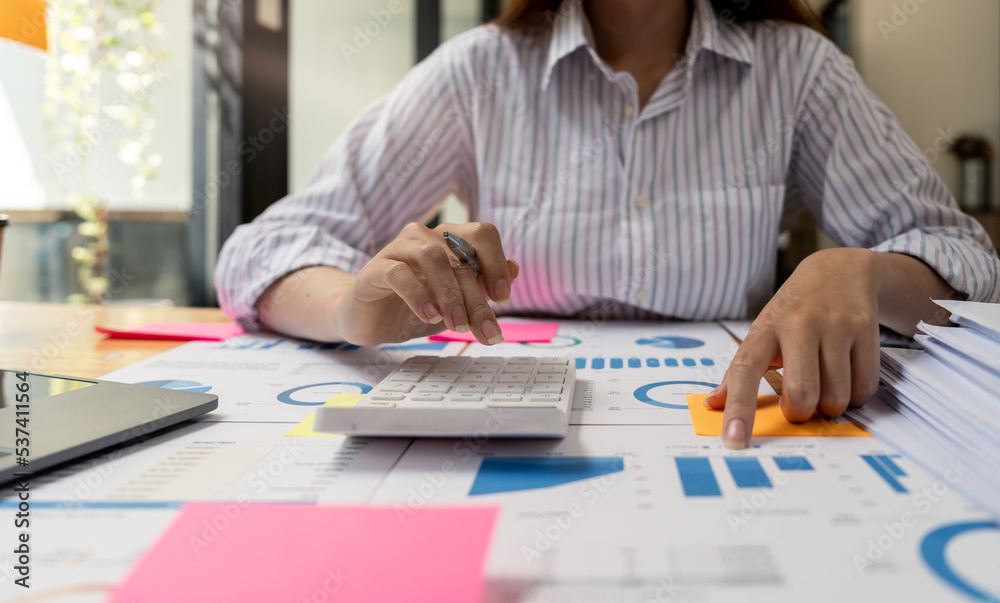Financial Businesswomen analyze the graph of the company's performance to create profits and growth, Market research reports and income statistics, Financial and Accounting concept. Financial Businesswomen analyze the graph of the company's performance to create profits and growth, Market research reports and income statistics, Financial and Accounting concept.