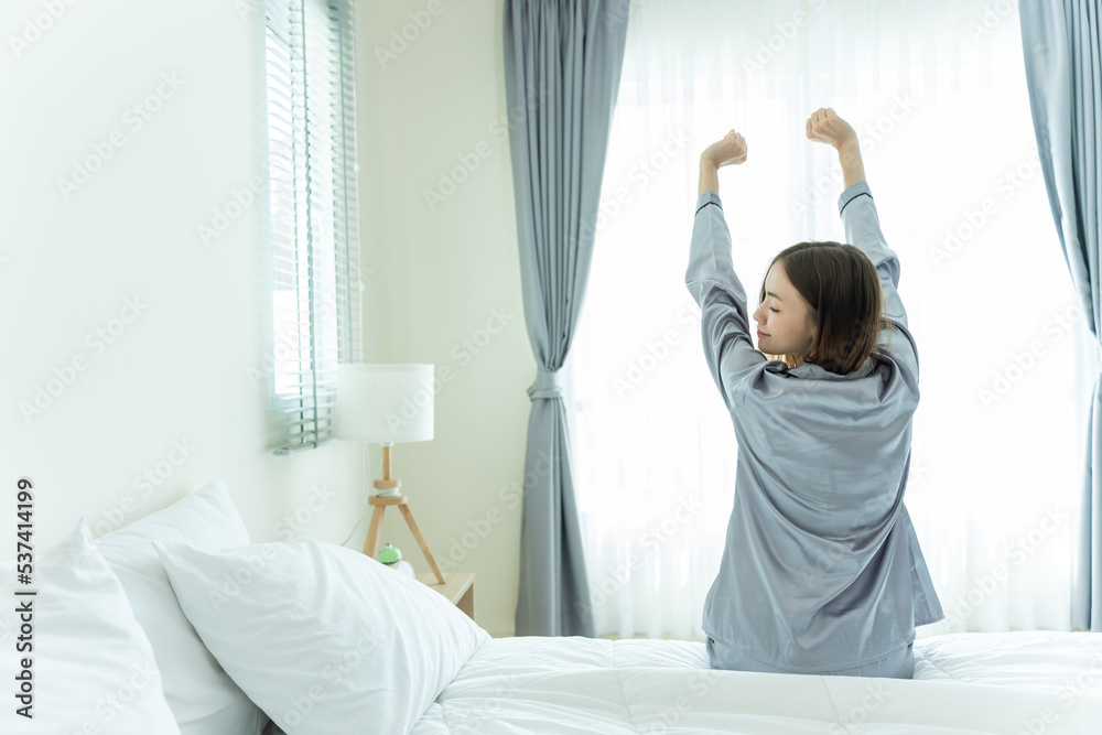 Beautiful Caucasian girl in pajamas wake up and streching in morning. Beautiful Caucasian girl in pajamas wake up and streching in morning.
