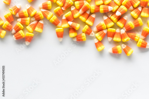 Candy corn forming a border at the top of the frame with copy space below.