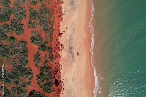 Cape Peron view from the sky. Aerial picture of orange land, beach and the ocean in Shark Bay, Western Australia. Top down of two people on the beach in francois peron national park Australia.