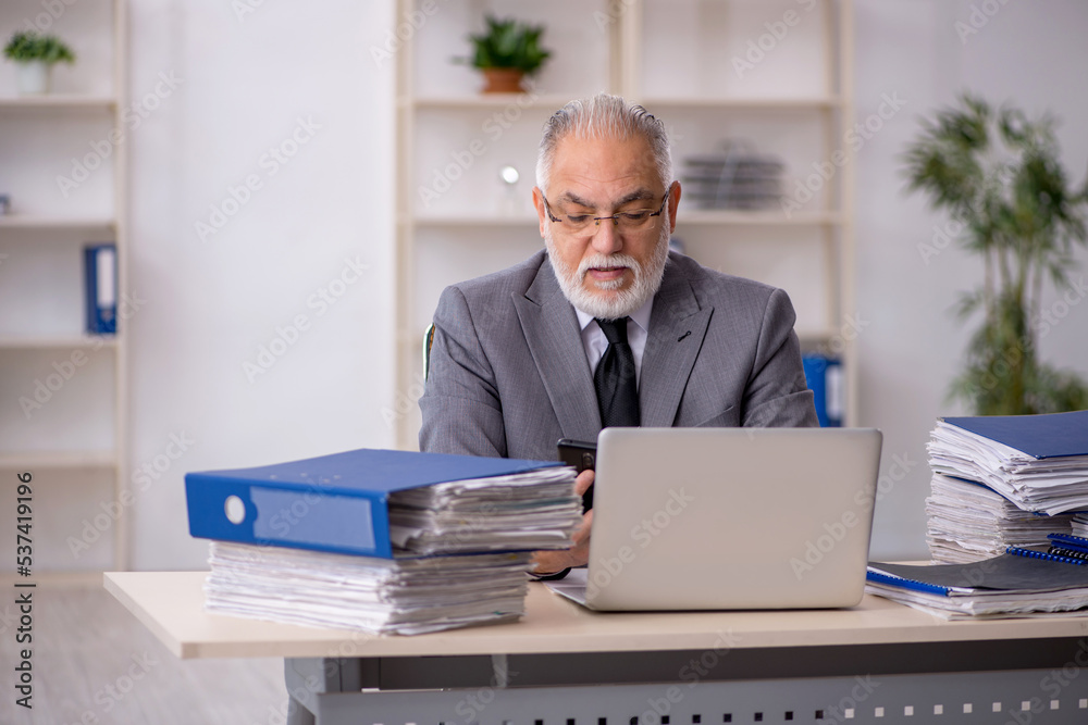 Old male employee and too much work in the office Old male employee and too much work in the office