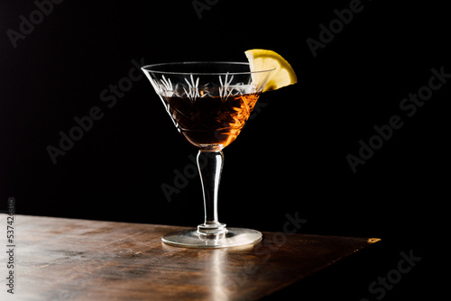 Martinez cocktail a variation of the classic Martini with black background photo