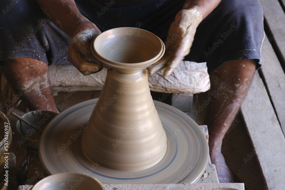 9 October 2022, Pune, India, Indian potter making Diya (oil lamps) or earthen lamps for Diwali Festival with clay, Handwork craft. 9 October 2022, Pune, India, Indian potter making Diya (oil lamps) or earthen lamps for Diwali Festival with clay, Handwork craft.
