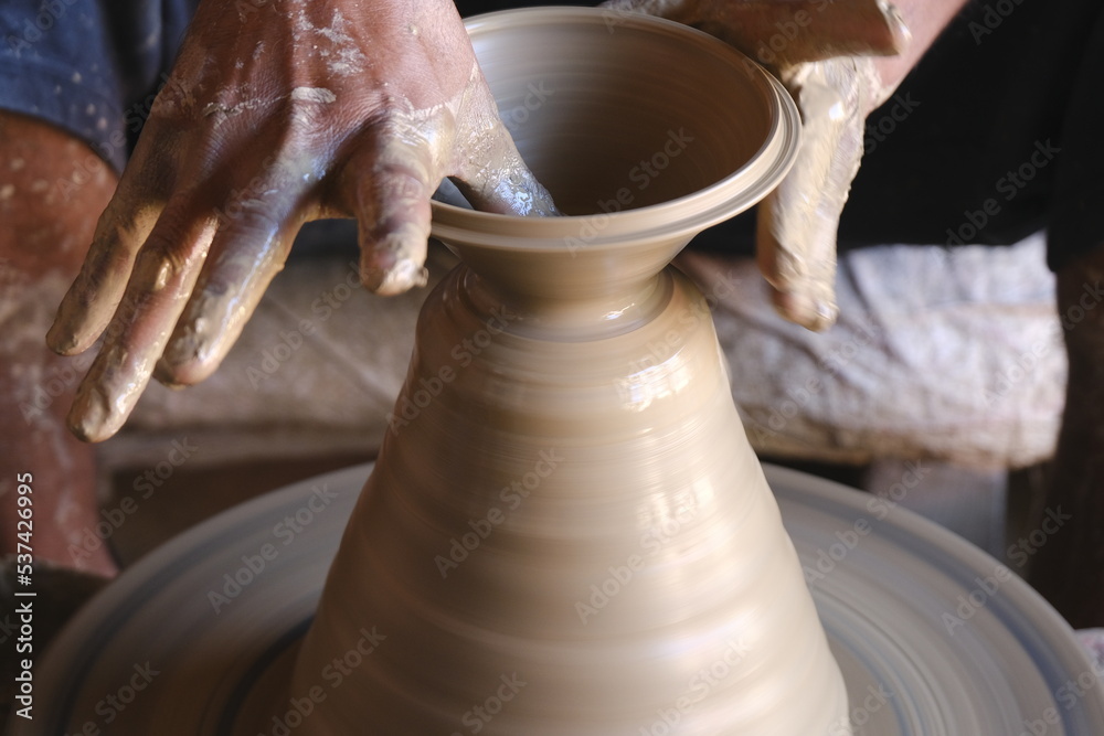 9 October 2022, Pune, India, Indian potter making Diya (oil lamps) or earthen lamps for Diwali Festival with clay, Handwork craft. 9 October 2022, Pune, India, Indian potter making Diya (oil lamps) or earthen lamps for Diwali Festival with clay, Handwork craft.