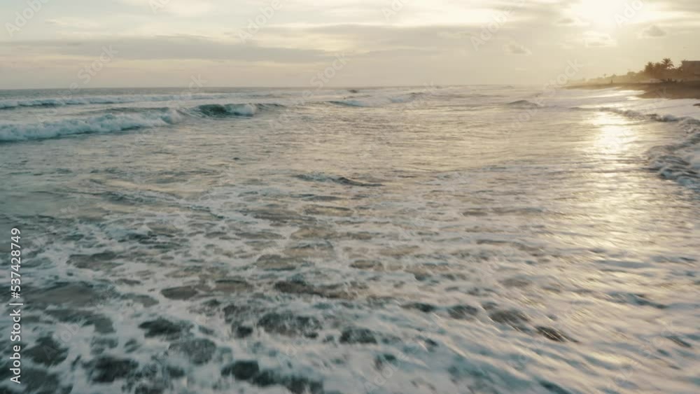 Ocean Waves And Black Sand Beach Of El Paredon In Guatemala At Sunset - drone shot Ocean Waves And Black Sand Beach Of El Paredon In Guatemala At Sunset - drone shot