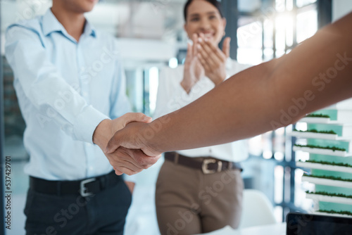 Handshake, welcome and meeting of employee at a corporate company with clapping of hands. Business people with applause and shaking hands for partnership, support and agreement of deal at work