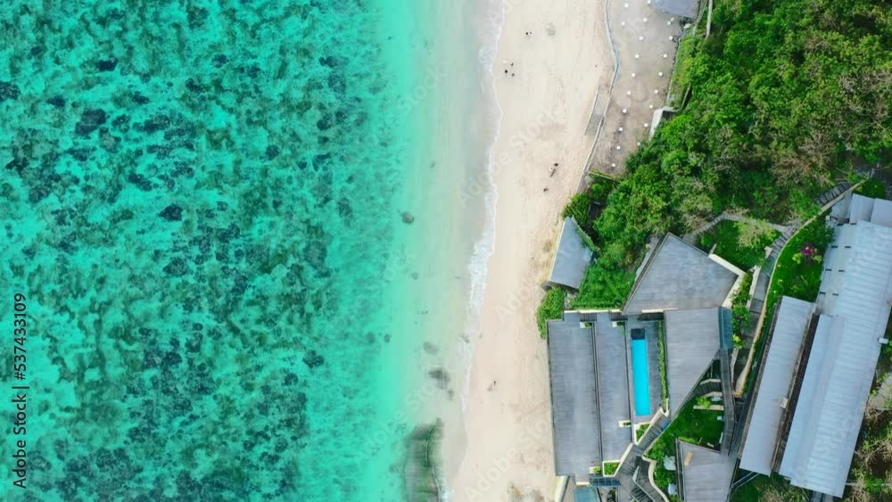 aerial top down of tropical blue ocean coastline at Karma Beach Club in Uluwatu Bali Indonesia aerial top down of tropical blue ocean coastline at Karma Beach Club in Uluwatu Bali Indonesia
