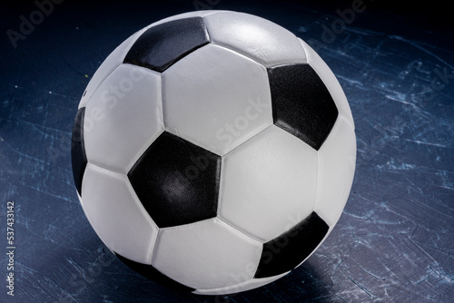Football ball on black background  Football ball sports equipment on dark wooden background.