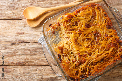 Jerusalem noodle kugel a Jewish pie for Shabbat Kodesh close-up in a glass bowl on the table. Horizontal top view from above photo