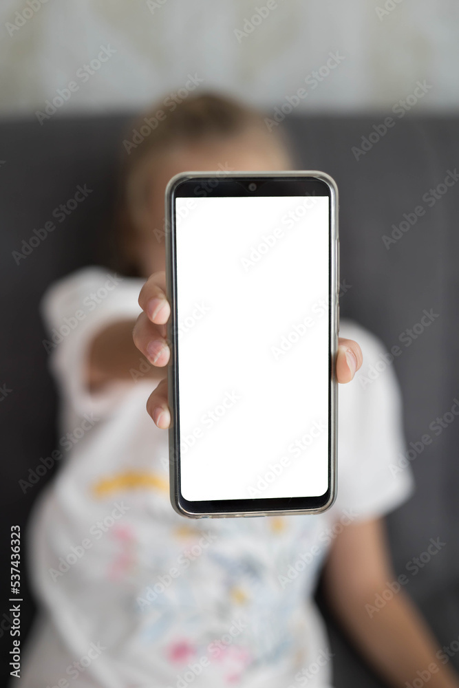 Black smartphone with a blank screen in the hands of a child Black smartphone with a blank screen in the hands of a child