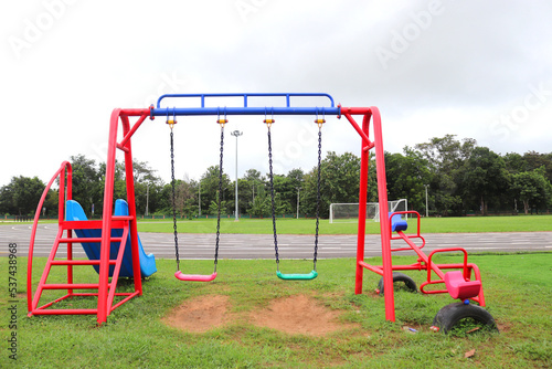 Empty chain swings on summer kids playground. Recreation activity with toy in the park in childhood.