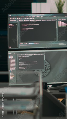 Vertical video: Multiple screens showing programming code in empty software it agency desk, parsing database algorithms and html text. Artificial intelligence network servers cloud computing in coding photo