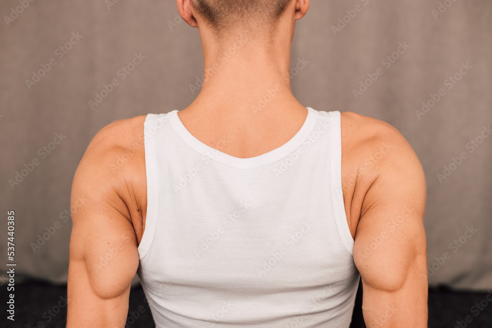 The back of a athlete. Muscles on the hands. Rear view. Fitness Yoga Pilates