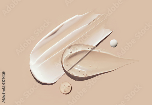 cosmetic smears of creamy texture on a pastel beige background	
