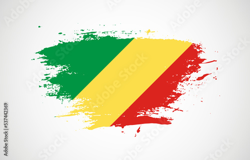 Grunge brush stroke with the national flag of Republic of the Congo on a white isolated background