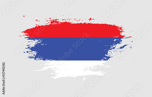 Grunge brush stroke with the national flag of Republika Srpska on a white isolated background