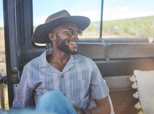 Comic, happy and black man on a road trip in van during holiday on the countryside of California. Thinking, relax and free person with smile in car during vacation in nature for travel and adventure