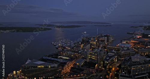Oslo Norway v56 low level drone flyover aker brygge and tjuvholmen neighborhoods capturing illuminated downtown cityscape and inner oslofjord waterway at dusk - Shot with Mavic 3 Cine - June 2022 photo