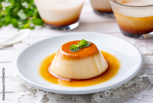 Cream caramel pudding with caramel sauce in plate photo