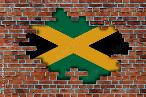 3D Flag of Jamaica behind the broken old stone wall background.