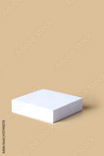 Abstract white the podium on beige background with shadow. Moke up and showplace for brand