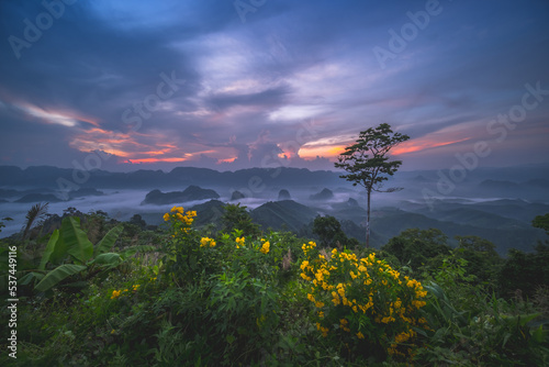 Doi Tapang (Doi Ta Pang) Viewpoint.The best view is looking eastwards towards the Khao Thalu mountain range, the mountain with a hole in it is the Landmark of Chumphon ,South of Thailand. photo