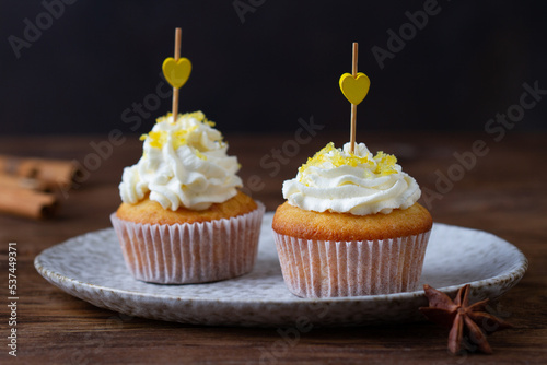 Pair of cupcakes with hearts on a dark background