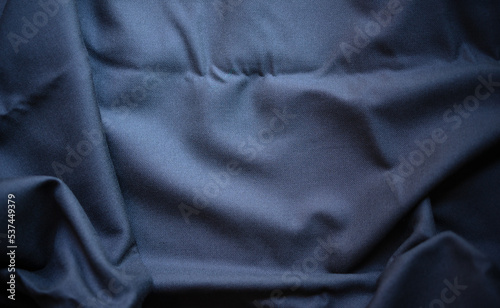 Black fabric. Photo of a dark-colored fabric texture. Black textile background.