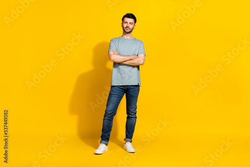 Full length photo of good looking serious man employer company owner dressed stylish outfit arm folded isolated on yellow color background