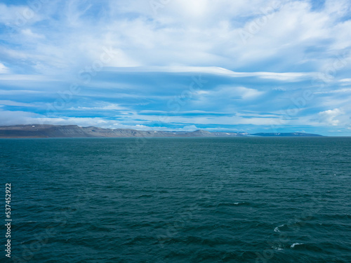 Spectacular panorama view of Wilhelmoya island with mountain range and blue sky. Torellneset, Nordaustlandet Spitsbergen, Norway. Tourism and vacations concept. photo