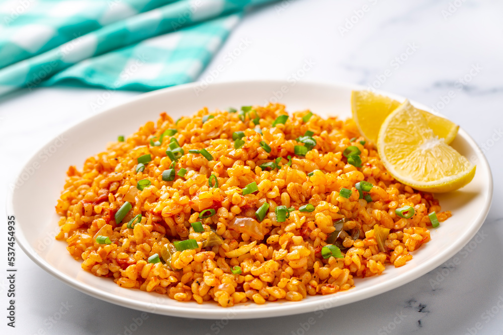 Traditional turkish bulgur pilaf with tomato sause in plate (Turkish name; meyhane pilavi) Traditional turkish bulgur pilaf with tomato sause in plate (Turkish name; meyhane pilavi)