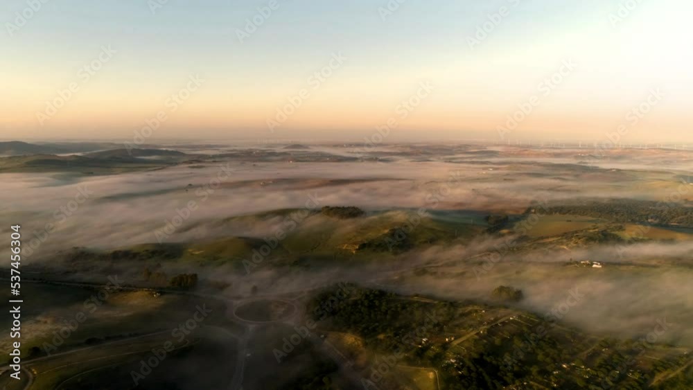 Aerial dolly drone shot over the landscape of medina sidonia during dawn with clouds, mountains and the landscape at sunrise. Cadiz Aerial dolly drone shot over the landscape of medina sidonia during dawn with clouds, mountains and the landscape at sunrise. Cadiz