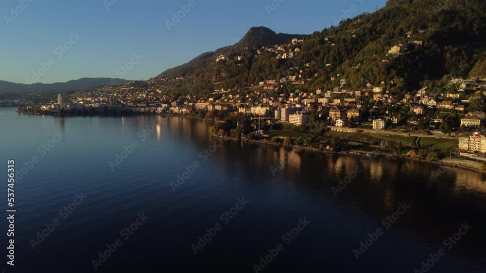 Fantastic aerial shot of the shore of Lake Leman, in the commune of Veytaux, in the canton of Vaud. You can see part of the city and during the golden hour. Fantastic aerial shot of the shore of Lake Leman, in the commune of Veytaux, in the canton of Vaud. You can see part of the city and during the golden hour.