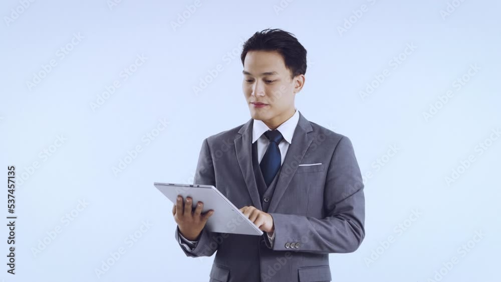 Young asian business woman in gray color suit using tablet touching chatting in vetical video 4K. Business concept. Young asian business woman in gray color suit using tablet touching chatting in vetical video 4K. Business concept.