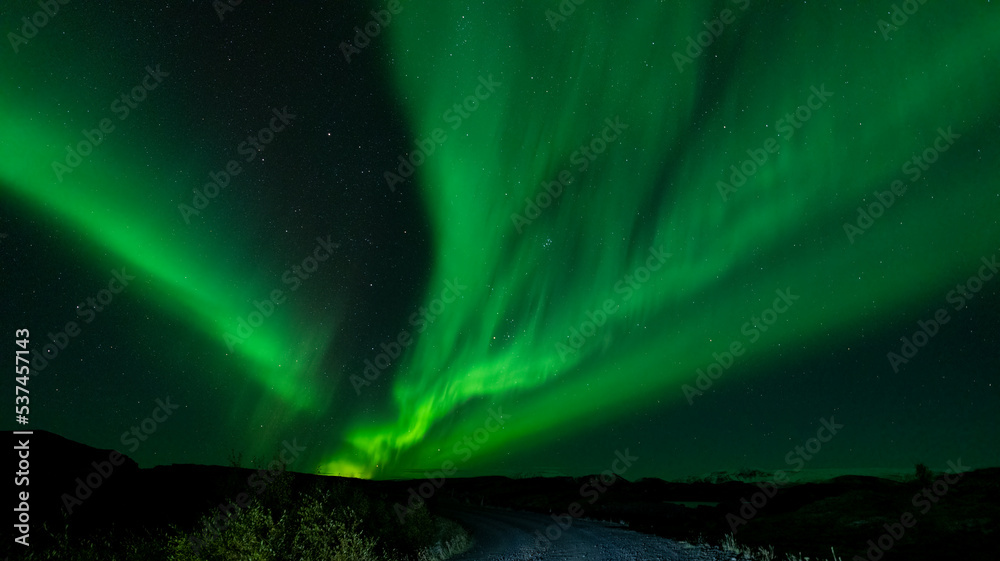 Northern lights green ray lights over track