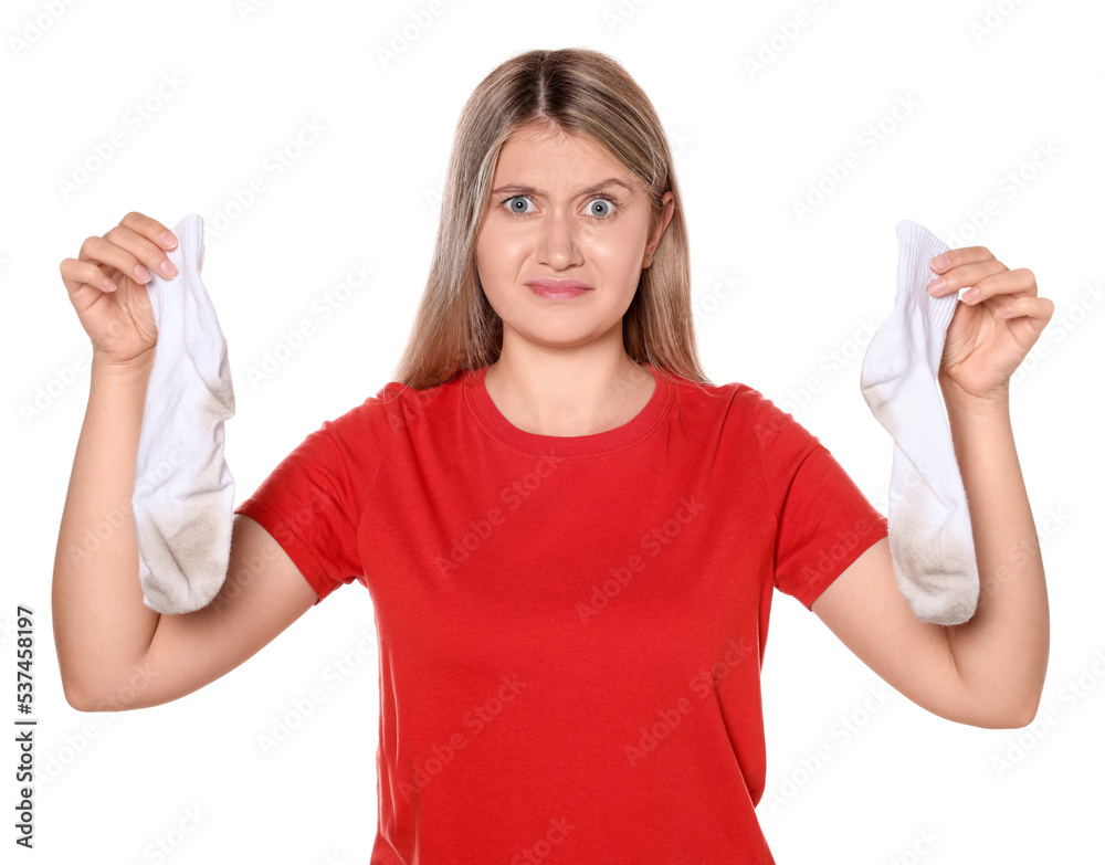 Young woman feeling bad smell from dirty socks isolated on white Young woman feeling bad smell from dirty socks isolated on white