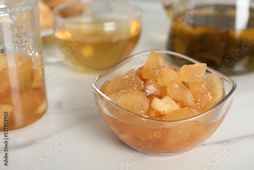 Delicious apple jam in bowl on white table, closeup