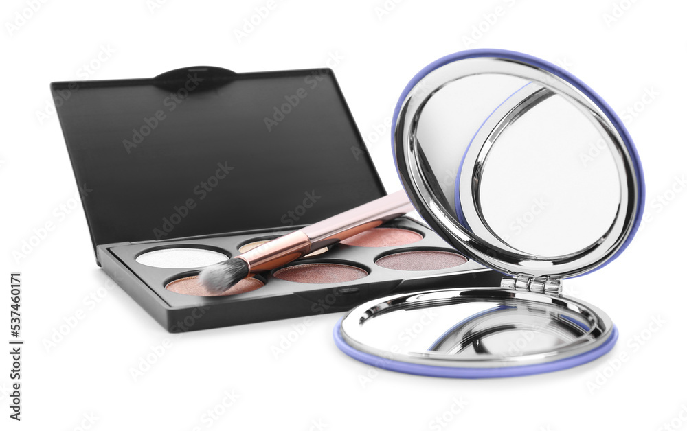 Stylish cosmetic pocket mirror and eyeshadows on white background Stylish cosmetic pocket mirror and eyeshadows on white background